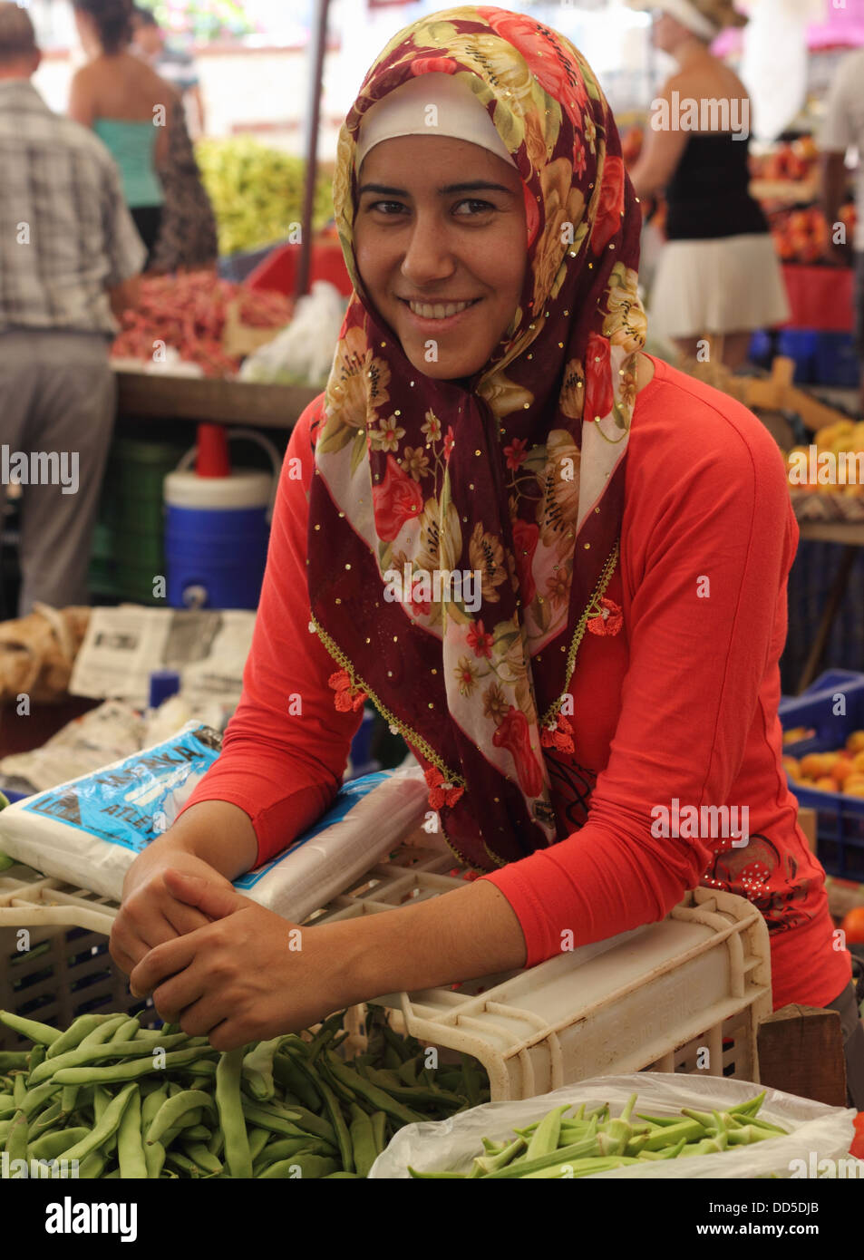 A pretty woman selling her fruit and vegetables Stock Photo