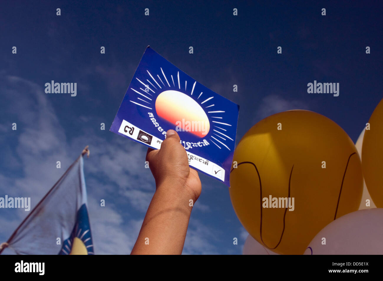 A man is holding a sign with the opposition CNRP party logo at political rally in Kampong Cham, Cambodia. Stock Photo