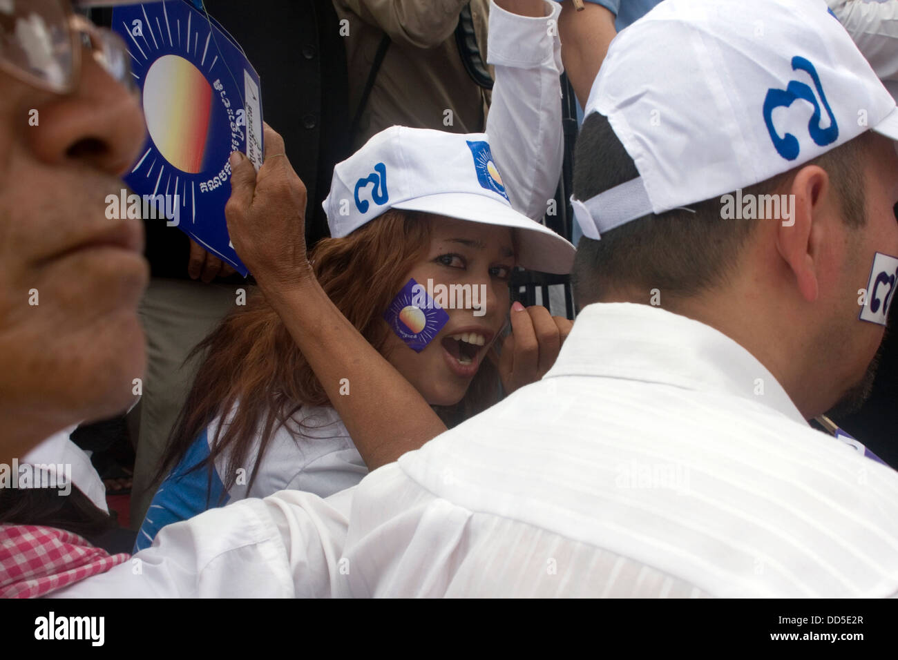 A young Cambodian woman is attending an election campaign rally for ...