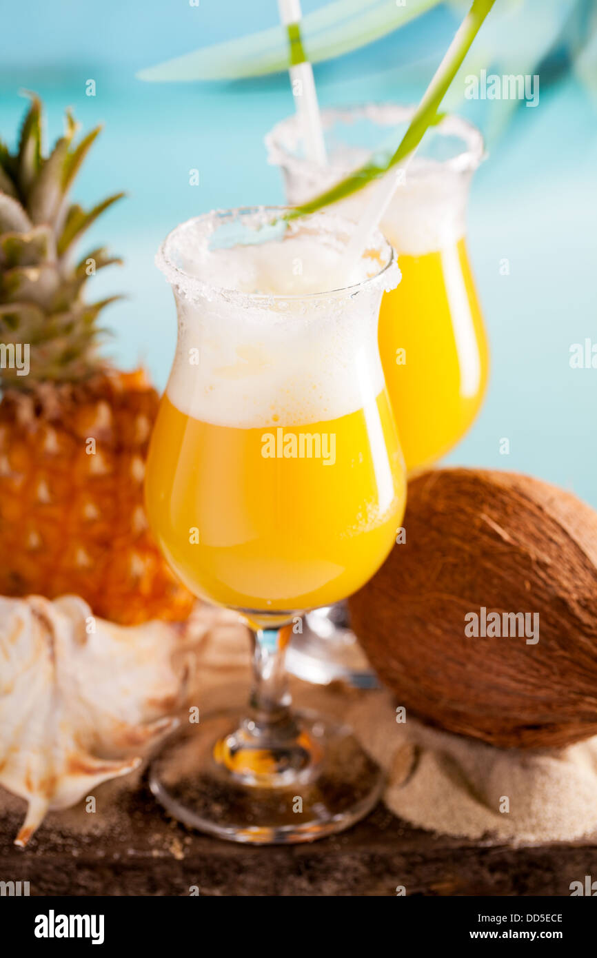 cocktail of pineapple juice, rum, liquer on table on sky background Stock Photo