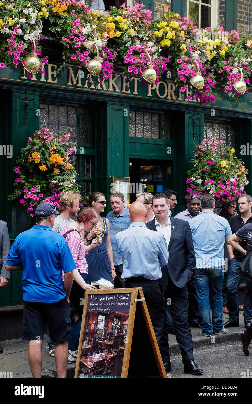 Customers standing outside The Market Porter pub in Borough Market in London in the UK. Stock Photo