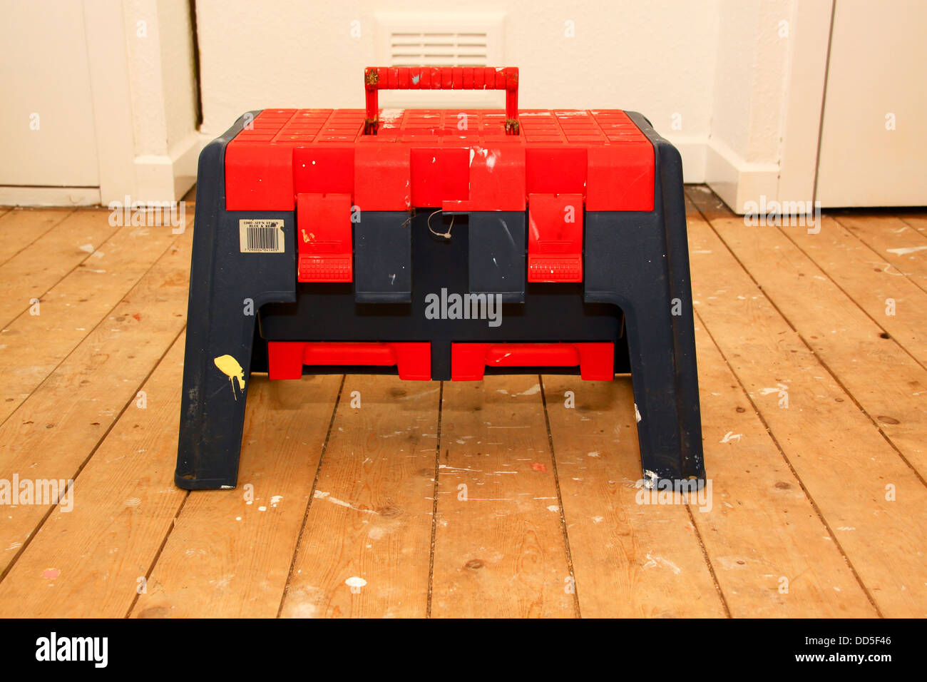 Step stool toolbox on bare floorboards Stock Photo - Alamy