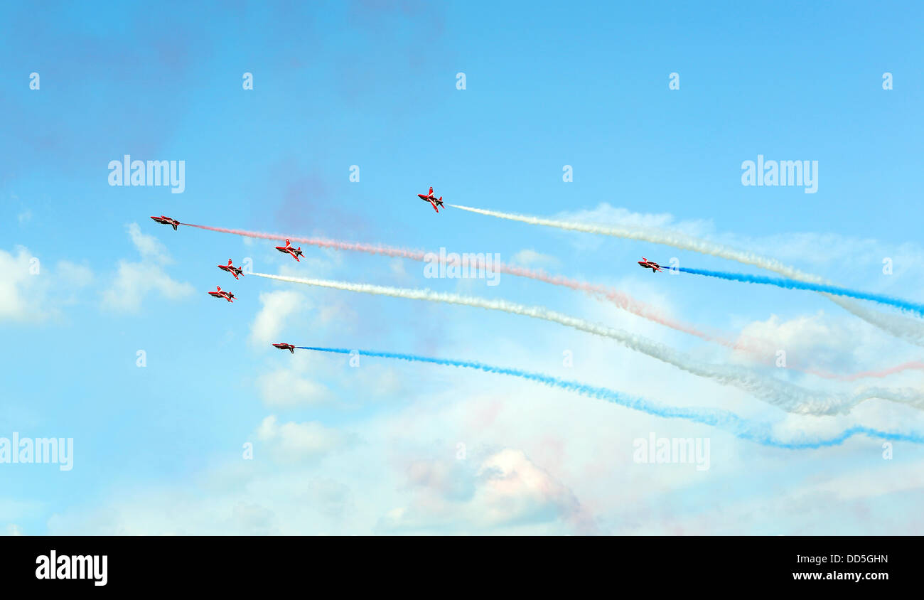 The Red Arrows stun the crowd at Wings and Wheels, Dunsfold, Surrey today with a spectacular display.The 'Wings' of the event treats visitors to outstanding and diverse 5 hour air displays which have confirmed participation from show favourites (on both days) the Red Arrows, Avro Vulcan, Battle of Britain Memorial Flight (Spitfire, Lancaster, Hurricane), Typhoon, Chinook, Tucano, RN Swordfish and Sea Fury, Apache Attack Helicopter, RN Lynx Black Cat Solo Helicopter Display, Team Breitling Wingwalkers, Glider FX and the Blades. Stock Photo