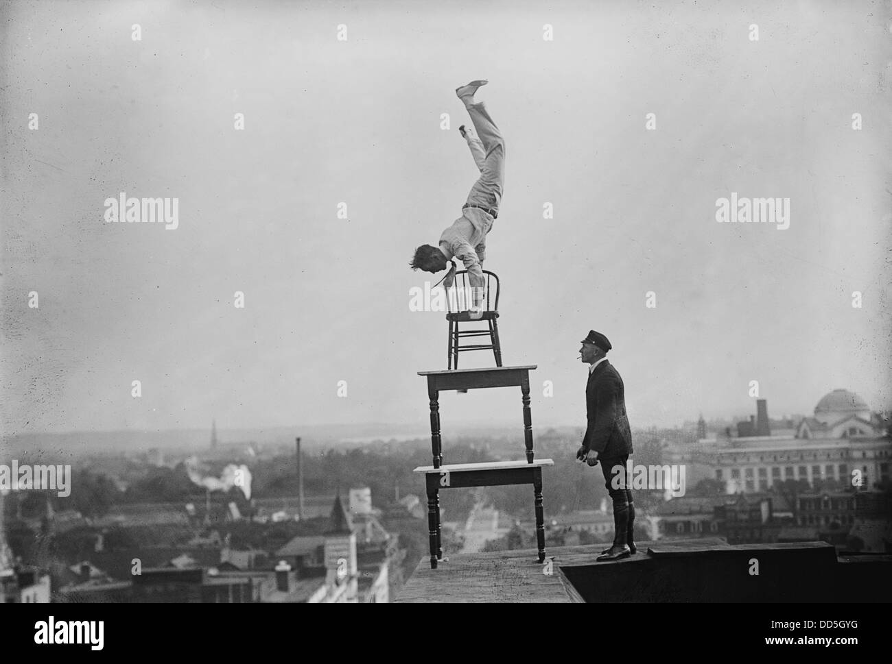 Jammie Reynolds, balancing on the on chairs on the edge of a rooftop in Washington, DC ca. 1921 Stock Photo