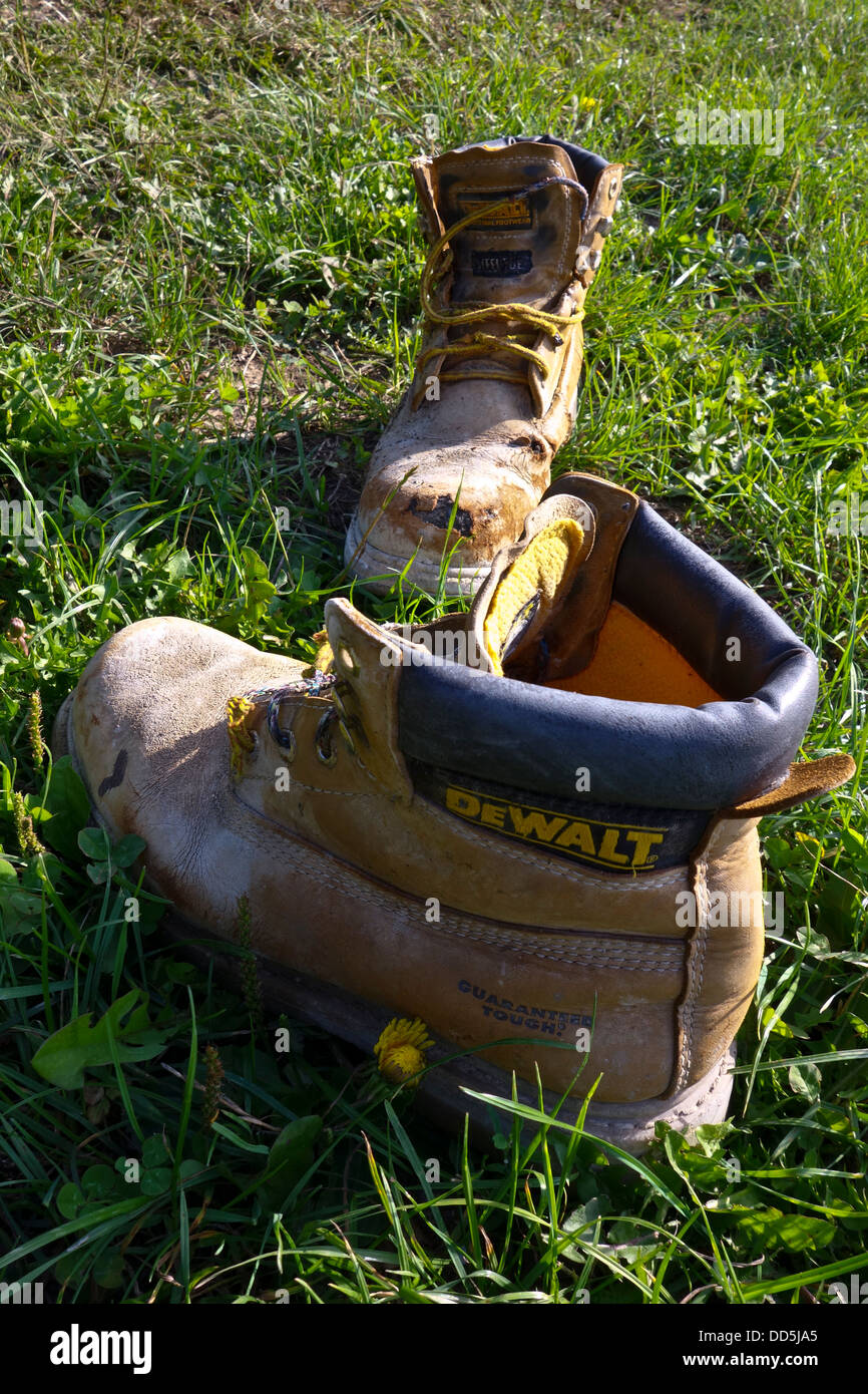 Old worn builders workmen boots Dewalt Stock Photo - Alamy