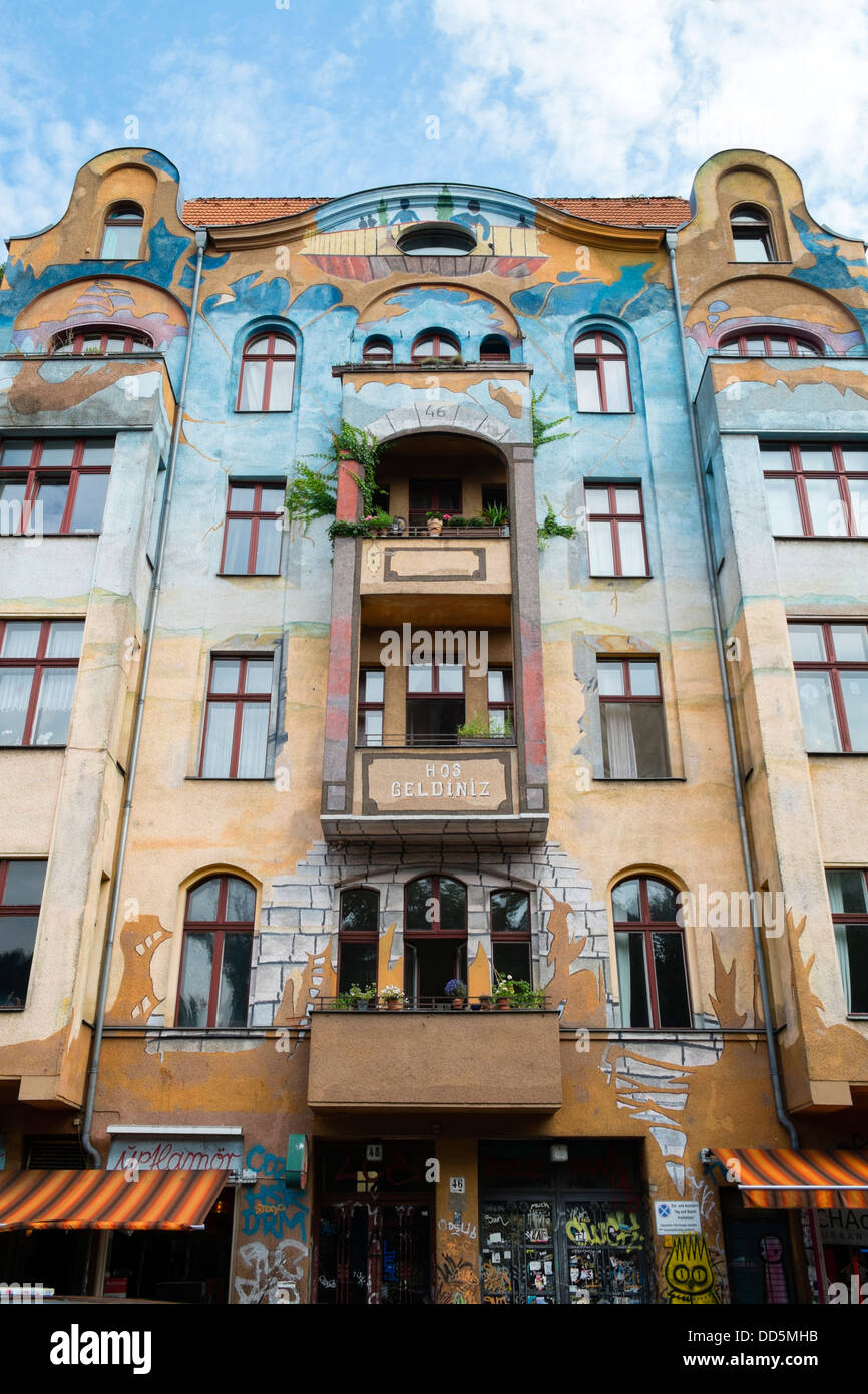 Murals painted on outside of apartment building in bohemian district of Kreuzberg in Berlin Germany Stock Photo