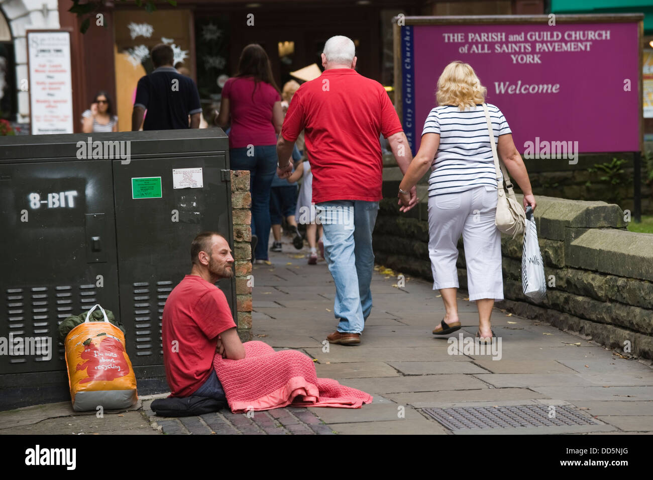 Homeless man begging being ignored in city centre of York North Yorkshire England UK Stock Photo
