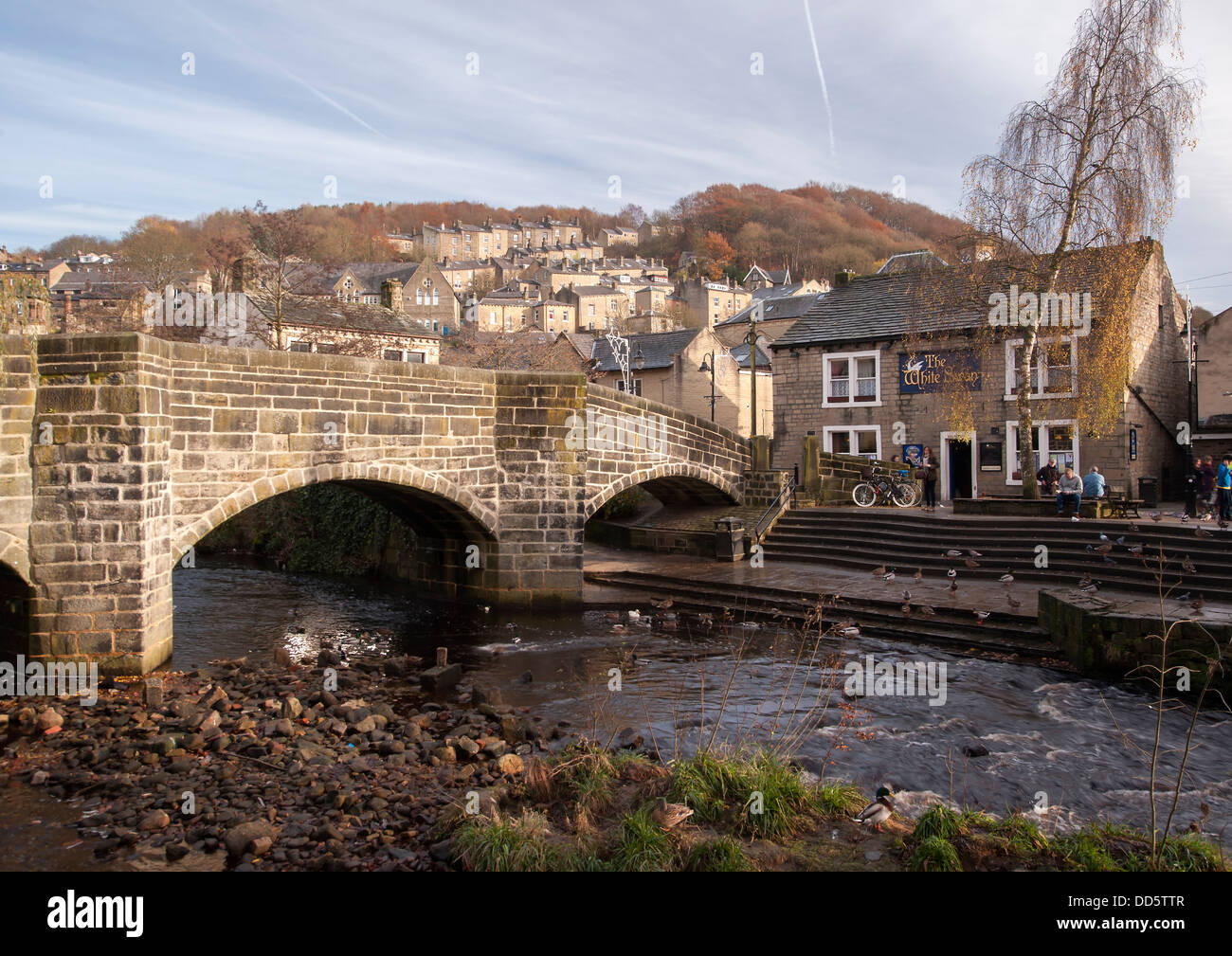 The packhorse bridge over Hebden water in the mill town of Hebden Bridge in Calderdale, West Yorkshire. Stock Photo