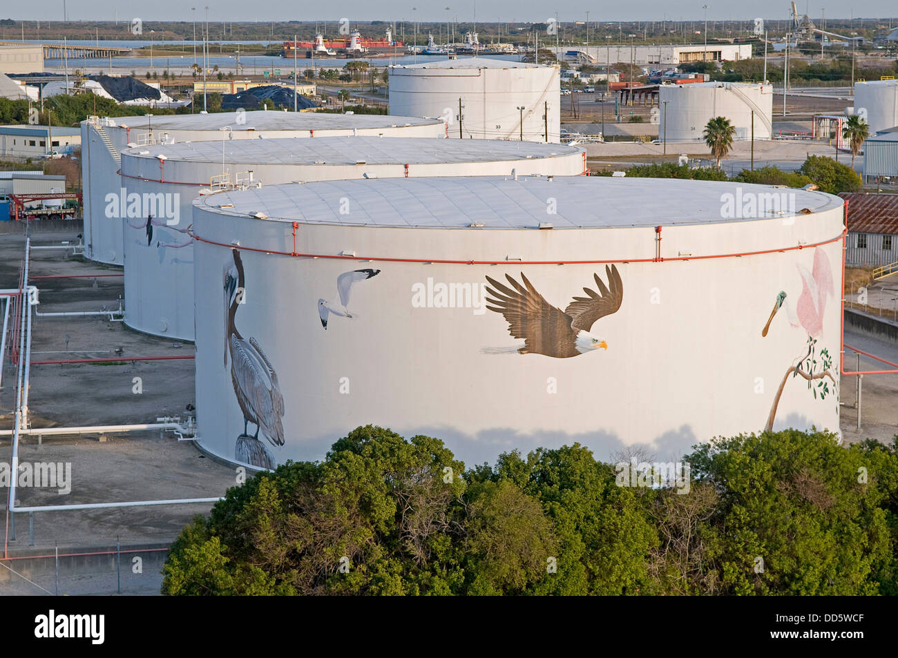 USA, Florida, Tampa, An attempt to put an environment friendly face on oil storage tanks along Maritime Boulevard. Stock Photo
