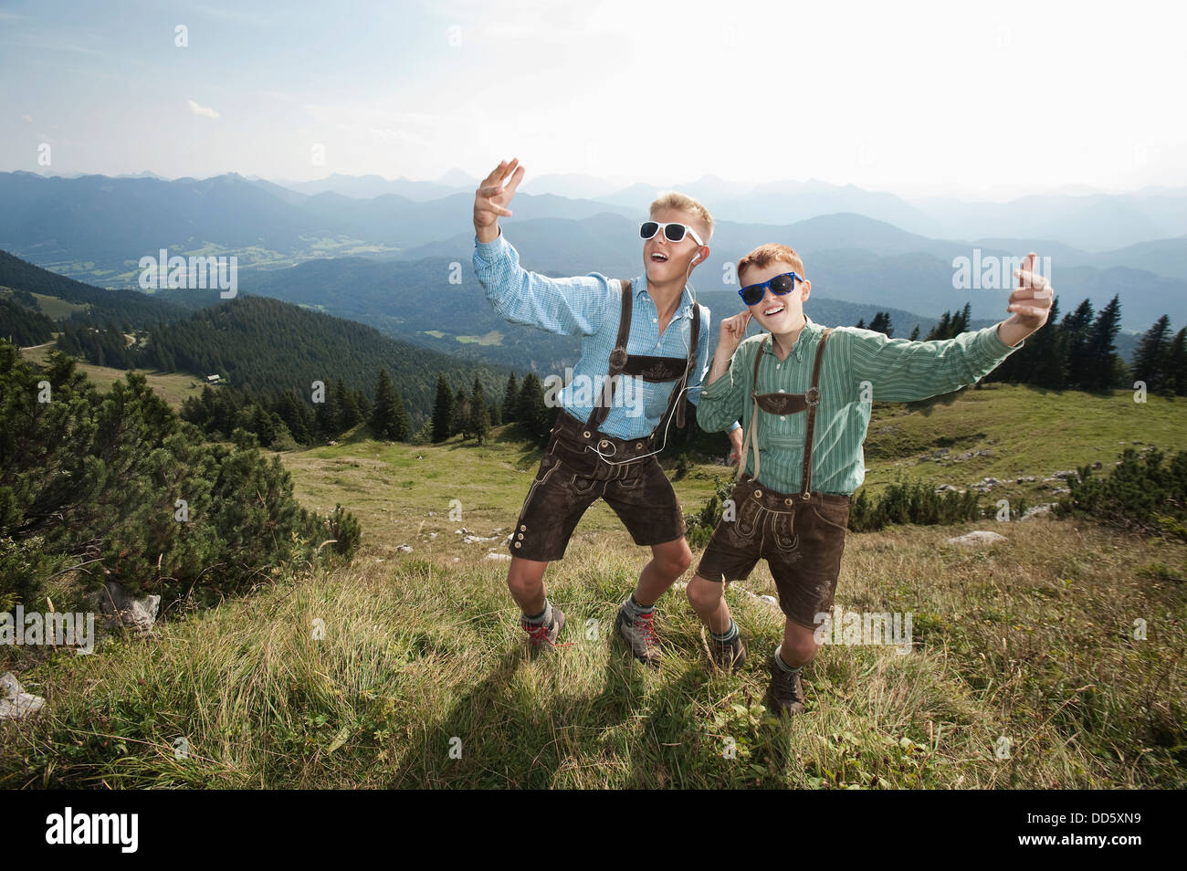 Germany, Bavaria, Two boys in traditional clothing fooling around in mountains Stock Photo