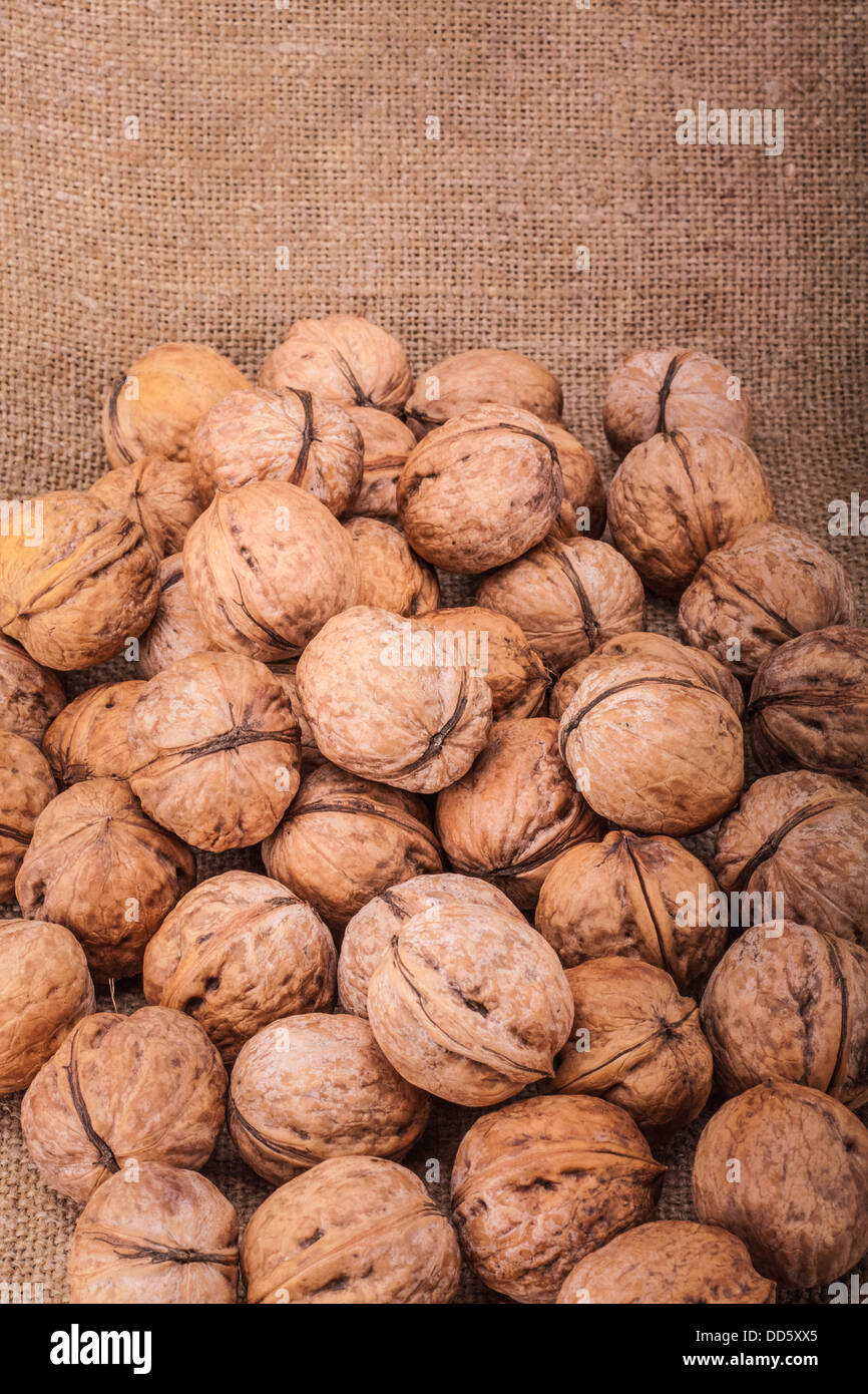 Unshelled walnut lying on sackcloth Stock Photo Alamy