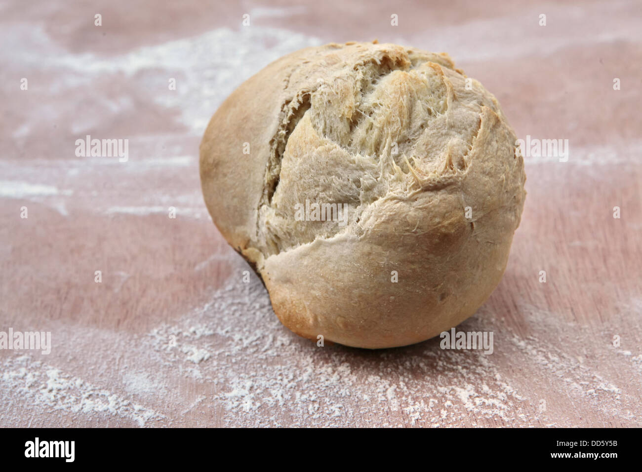 Freshly baked roll on a flour covered board in a bakery Stock Photo