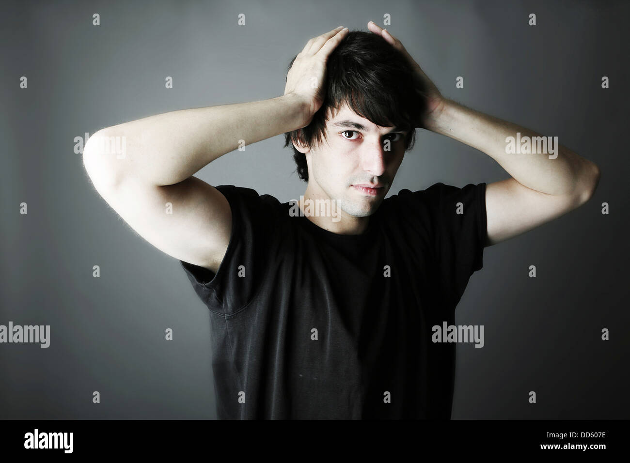 Portrait of young man against grey background, close up Stock Photo - Alamy