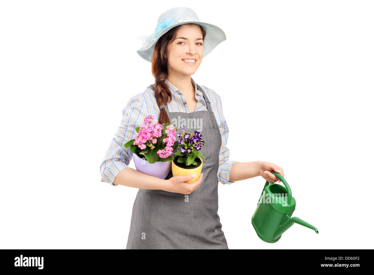 Female gardener holding flower pots and watering can Stock Photo - Alamy