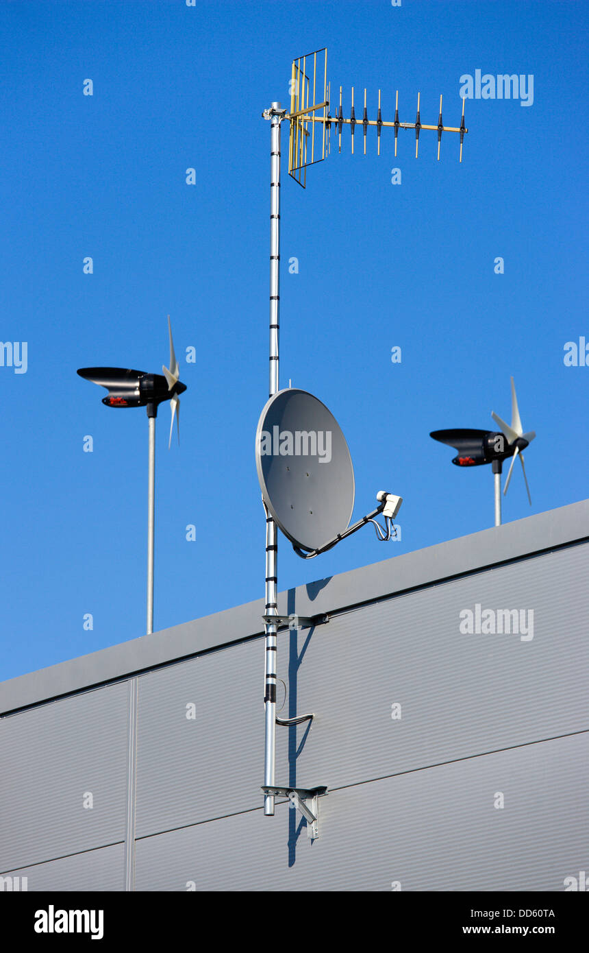 Industry Power Electricity Direct-drive wind generators designed for electric microgeneration with TV aerial and satellite dish. Stock Photo