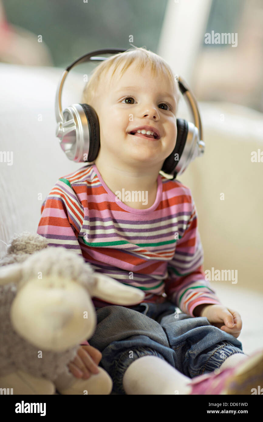 Toddler boy listens to music wearing headphones, Osijek, Croatia