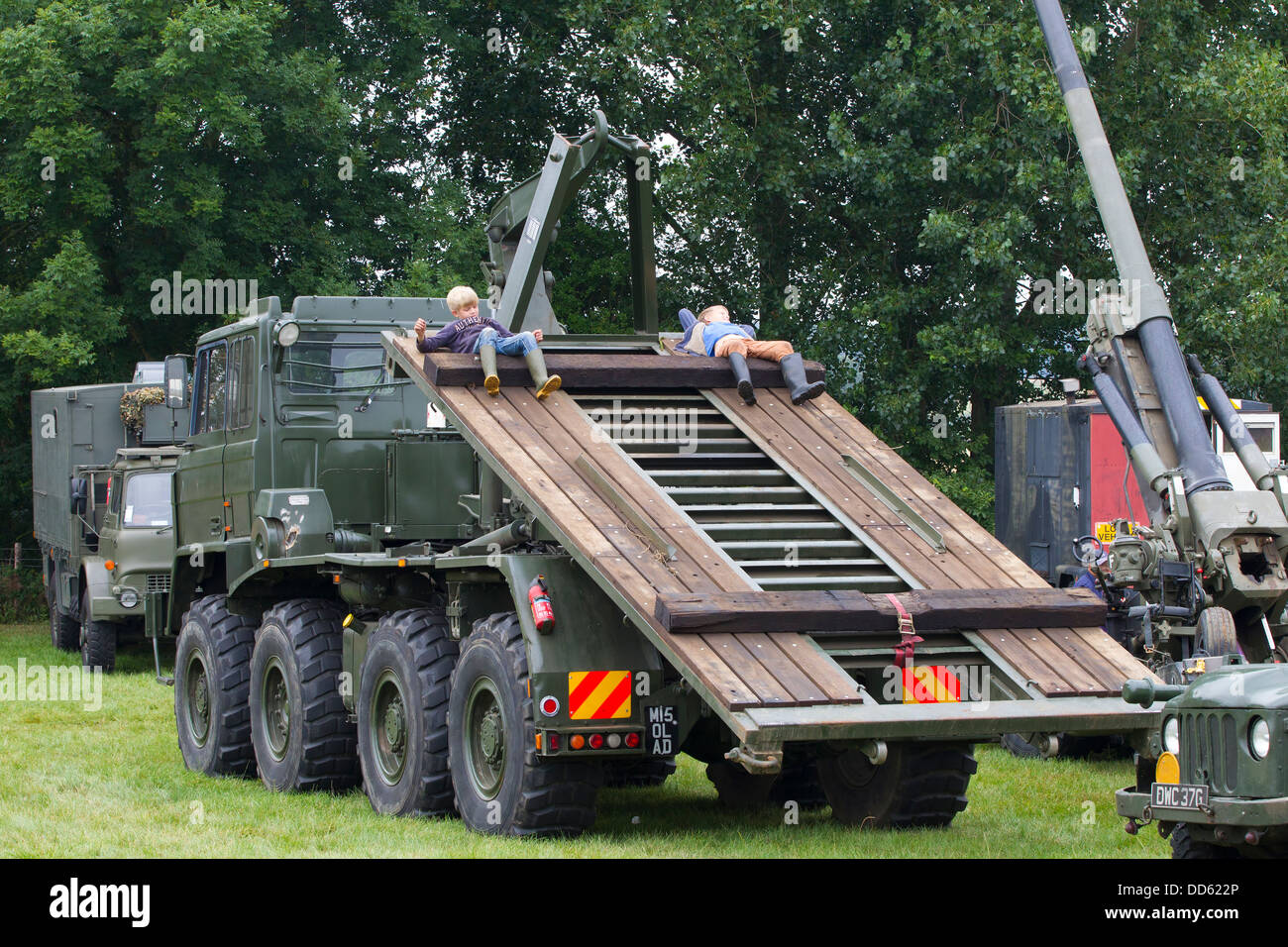 Large army vehicle carrier with children playing on it. Stock Photo