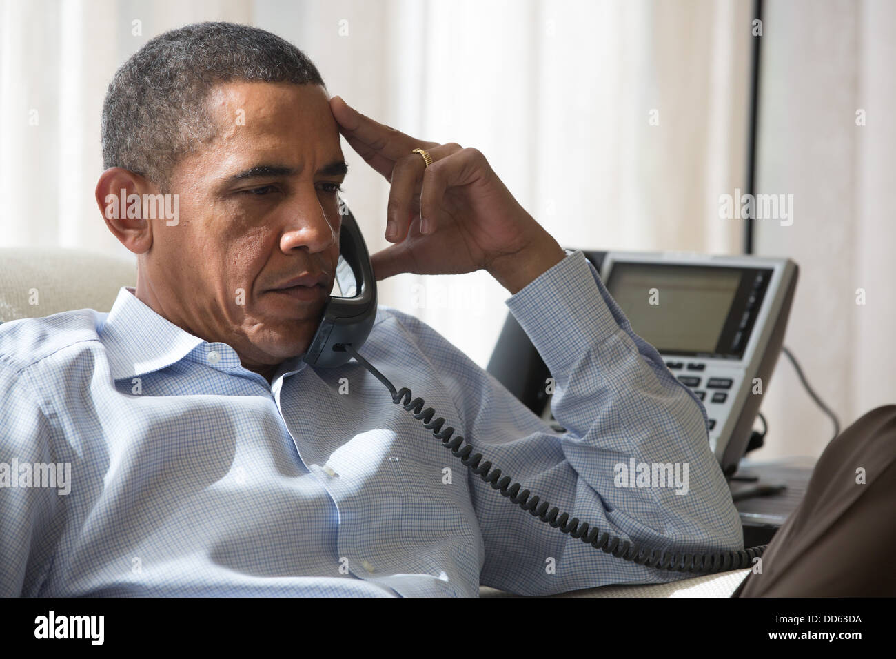 President Barack Obama speaks by phone with his National Security Staff regarding the situation in Egypt, while in Chilmark, Mass., Aug. 15, 2013. Stock Photo