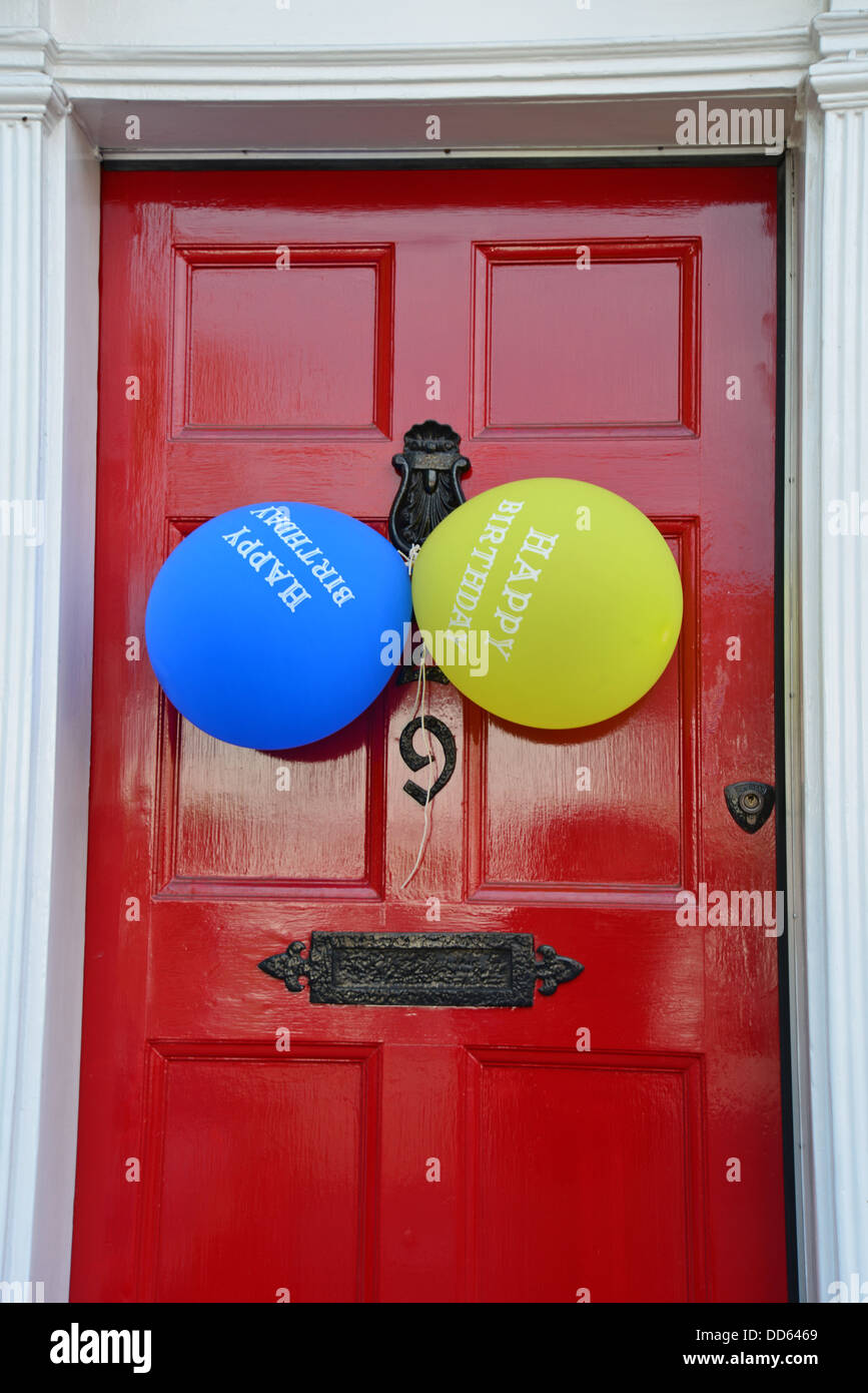 Birthday party balloons on house door, Castle Street, Farnham, Surrey