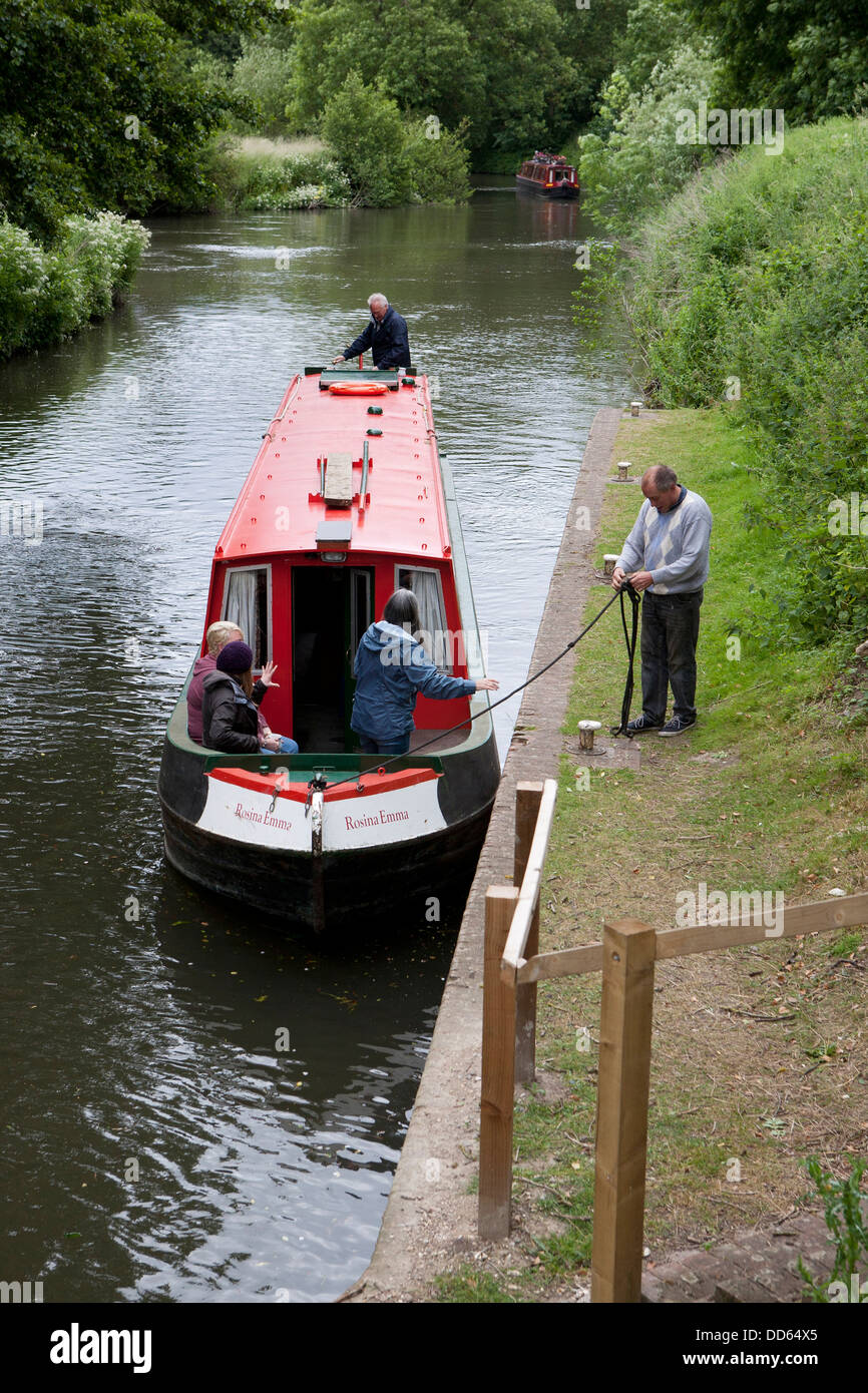 A narrow boat (barge) being moored up by a lock on the Kennet and Avon canal. Stock Photo