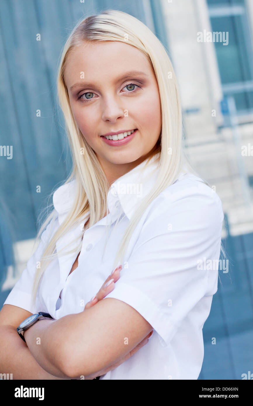 attractive young successful smiling business woman standing outdoor in ...
