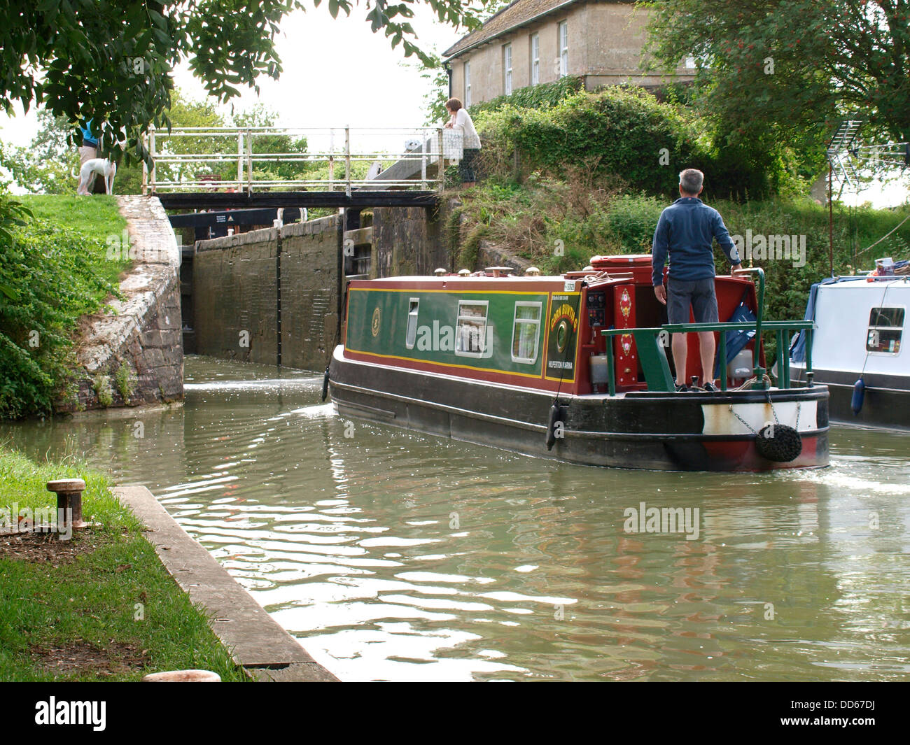 Narrow boat entering a lock on the Wilts and Berks Canal, Semington, Wiltshire, UK 2013 Stock Photo