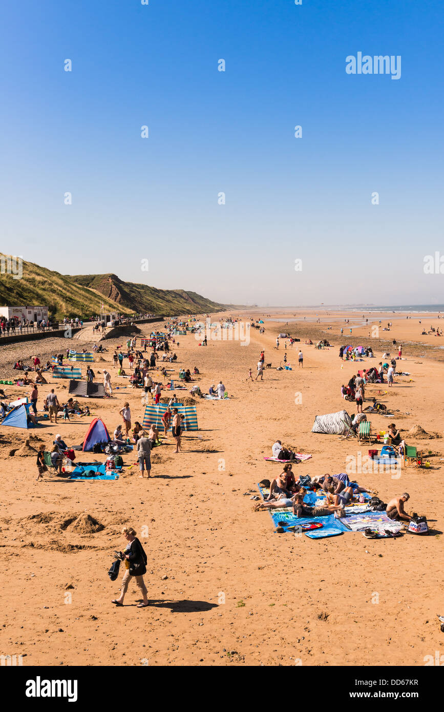 People enjoying the sunshine on Saltburn beach, North East coast, on the last bank holiday of the year 2013 Stock Photo