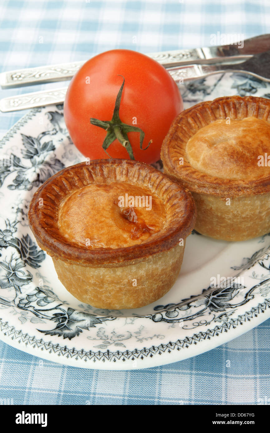 Traditional English pork pies in a picnic setting Stock Photo