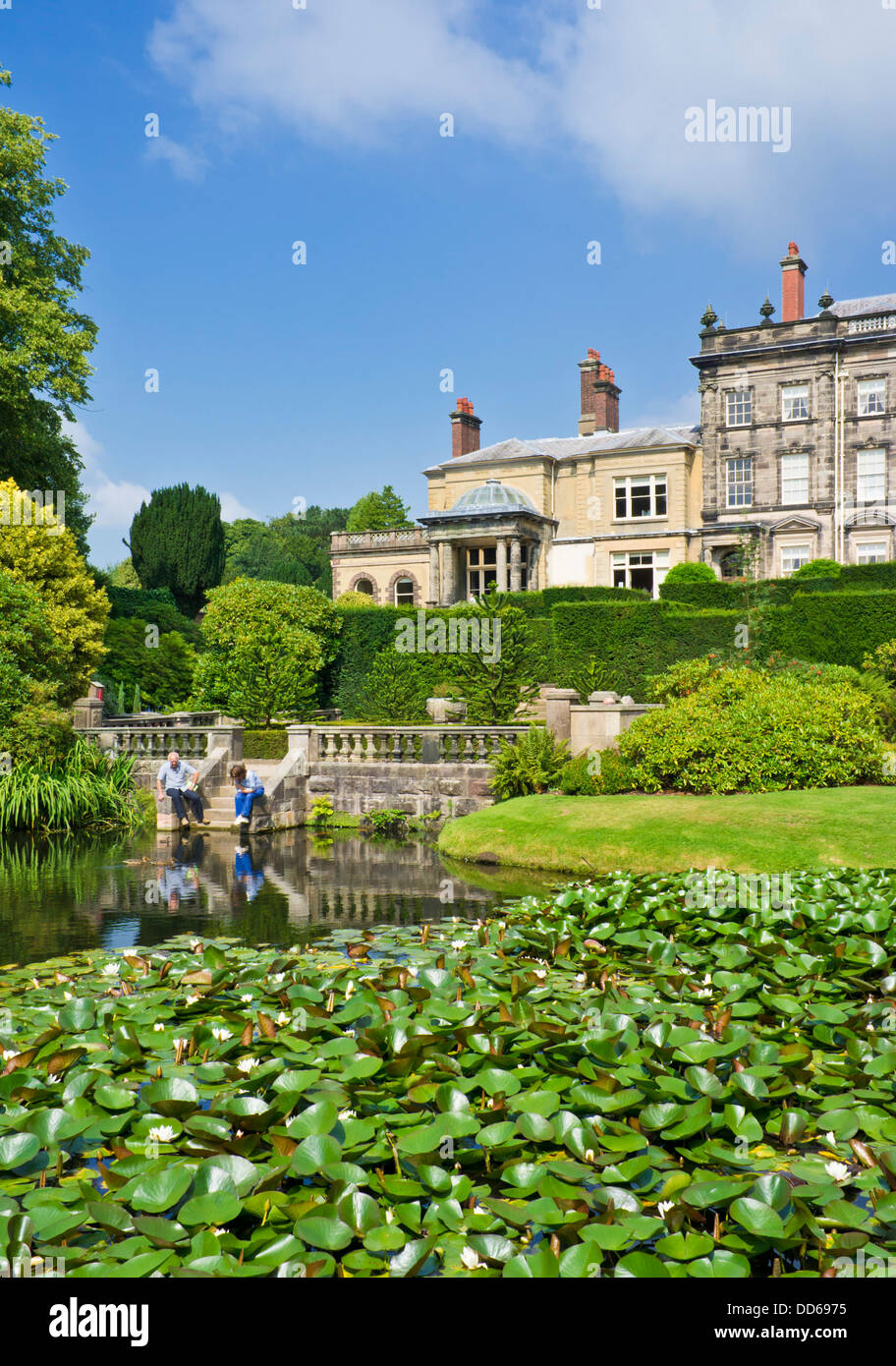 Biddulph grange victorian house and small lake with water lilies in landscaped gardens Staffordshire England UK GB EU Europe Stock Photo