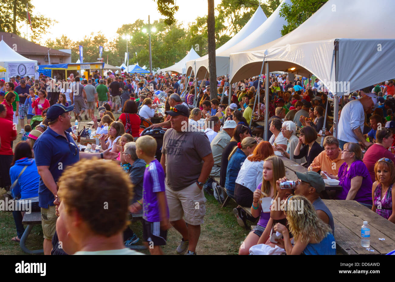 Crowd eating at the food tents of the Winona Peach Festival, near Hamilton, Ontario, Canada. Stock Photo