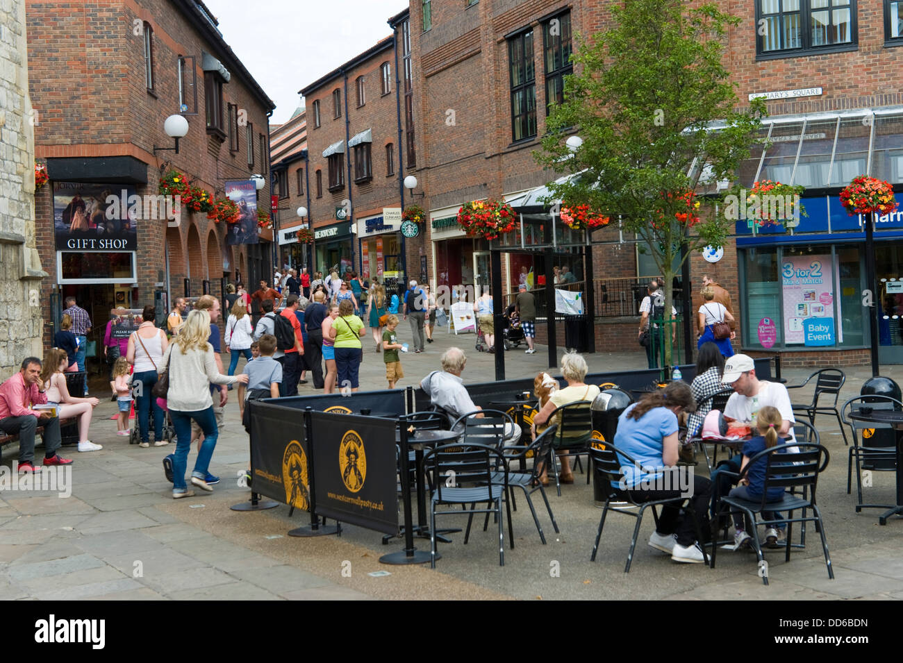 Tourists and shoppers stroll around St Mary's Square in city centre of