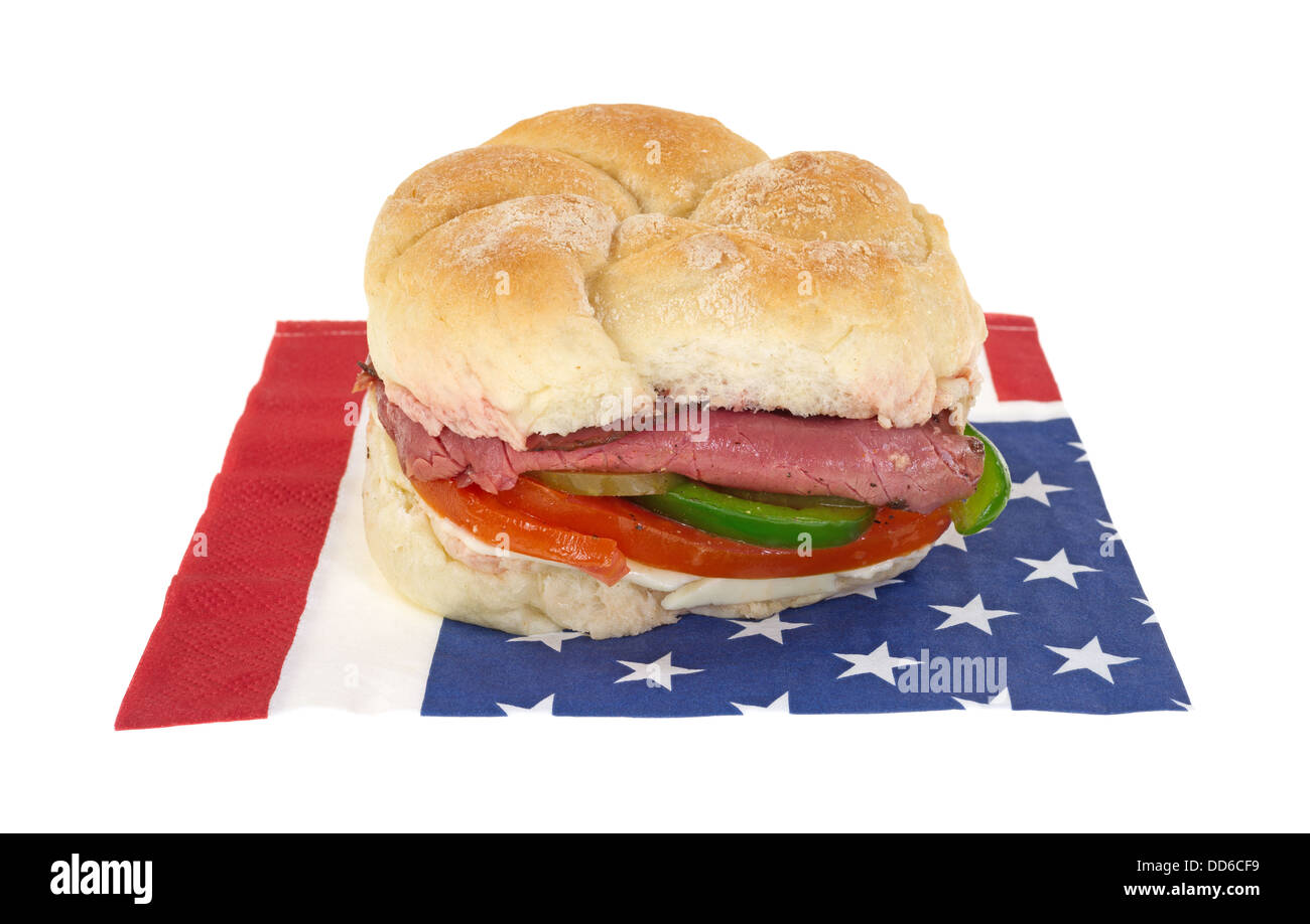 A roast beef bulky roll sandwich on a patriotic American flag napkin. Stock Photo