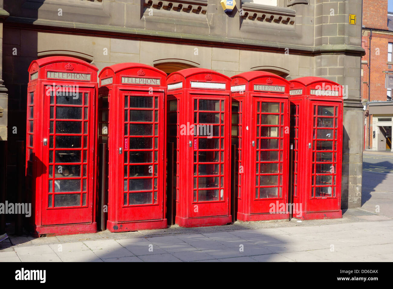 Five classic red British telephone type K6 boxes now disused Stock Photo