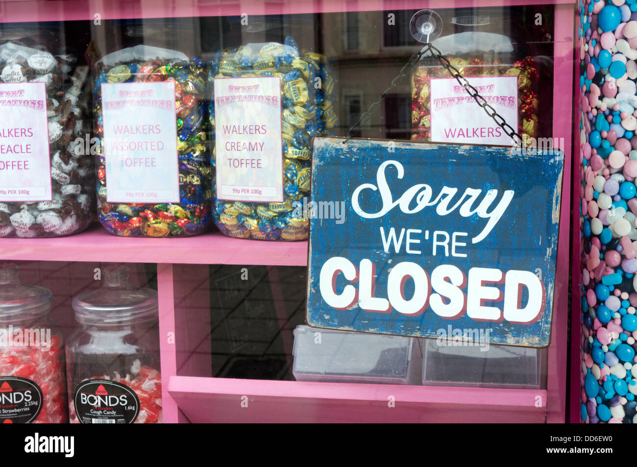 Closed sign in a sweet shop window. Stock Photo