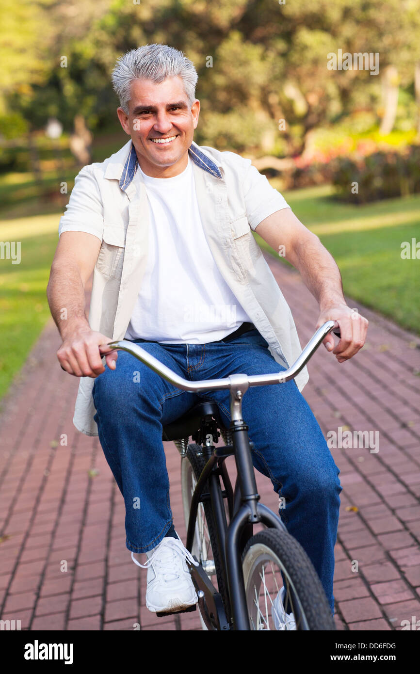Middle aged man riding a bike hi res stock photography and images Alamy