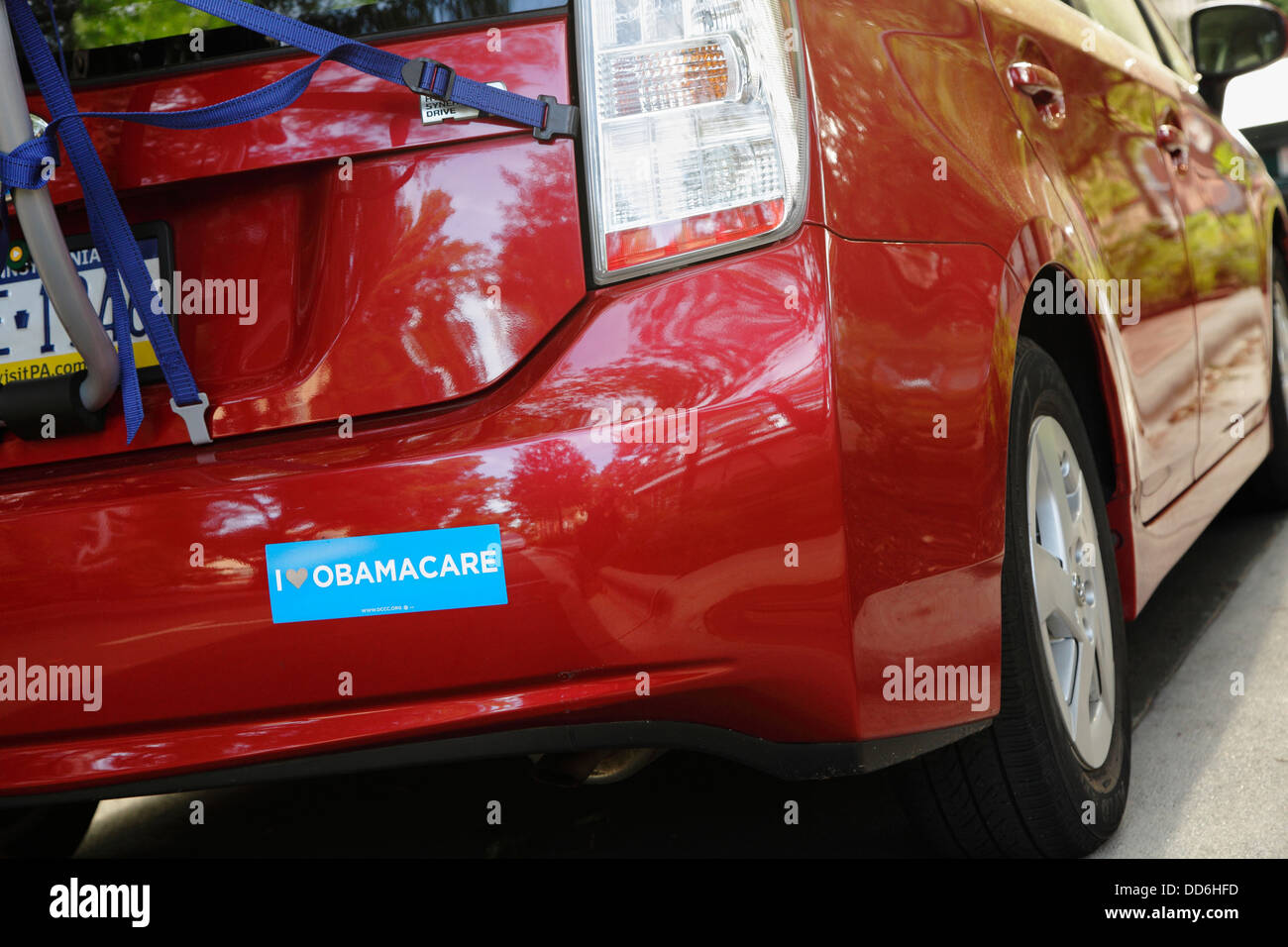 A bumper sticker that reads 'I Love Obamacare' on a hybrid vehicle parked on a public university campus, USA Stock Photo