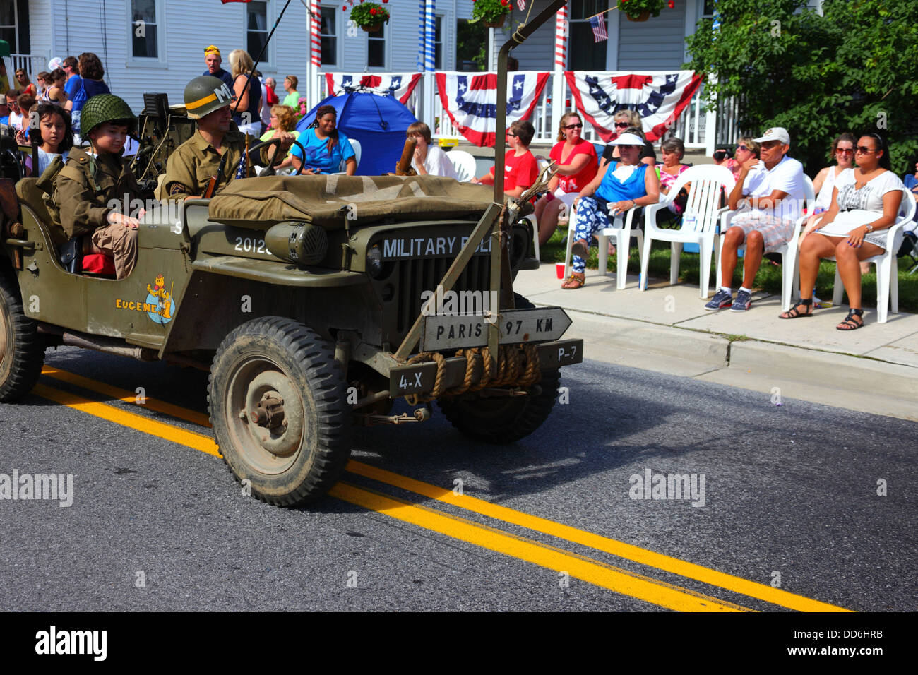 Soldier in military police jeep with Paris 97km sign on front, 4th of July Independence Day parades, Catonsville, Maryland, USA Stock Photo