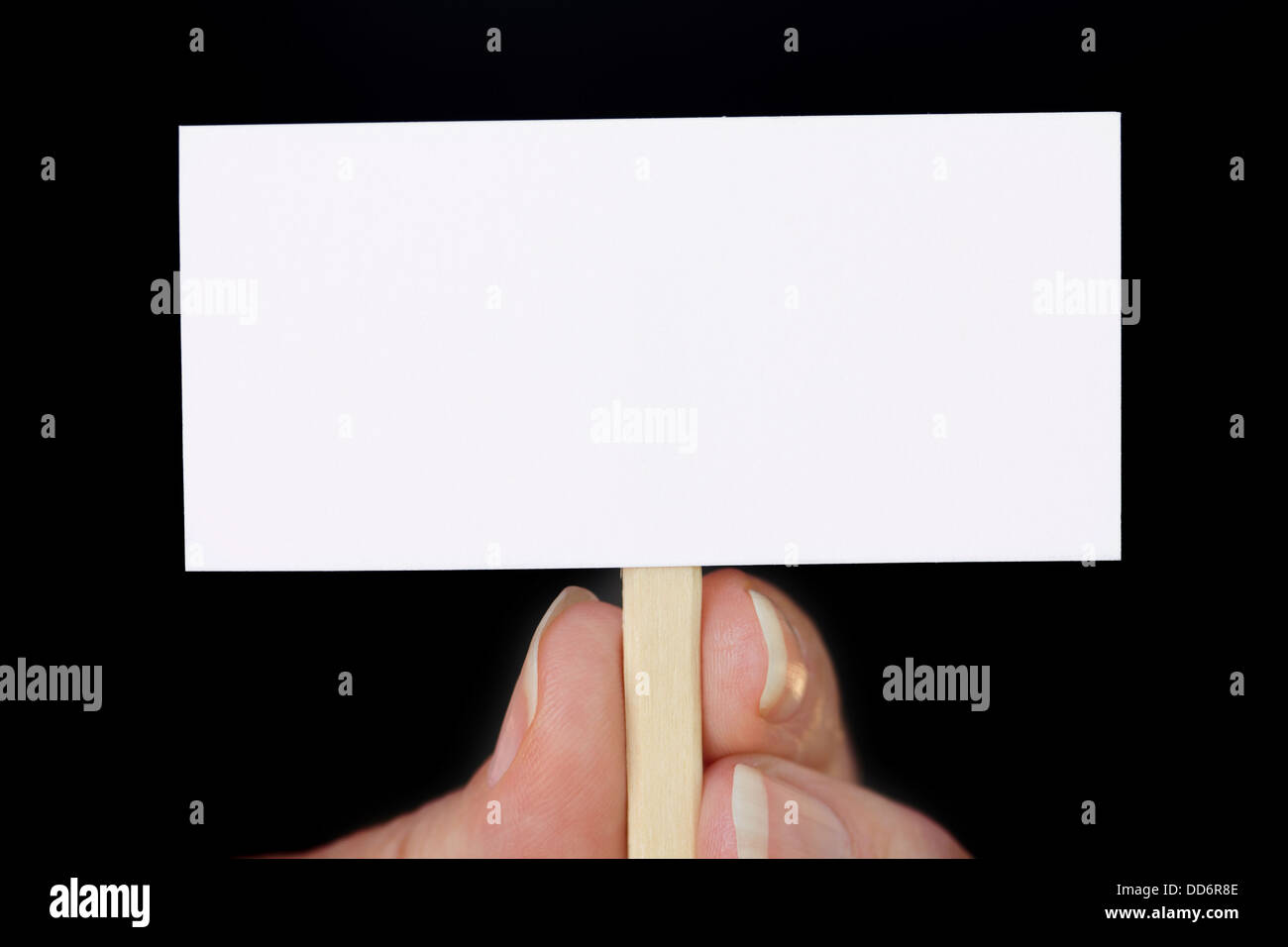 Hand Holding Tiny Sign on Black Stock Photo - Alamy