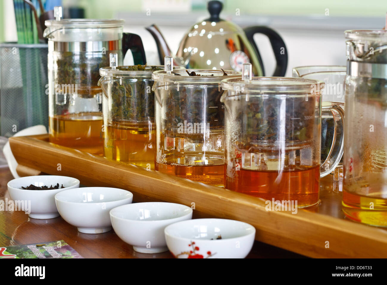Tea on plastic bowl and white teacup. Stock Photo