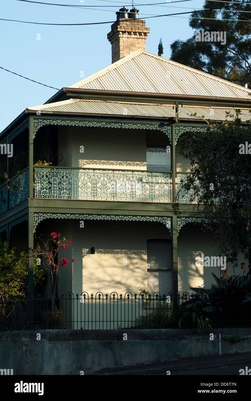 A traditional Victorian Sydney terrace house with verandah and ironwork lacing on balcony, photographed in the late afternoon. Stock Photo