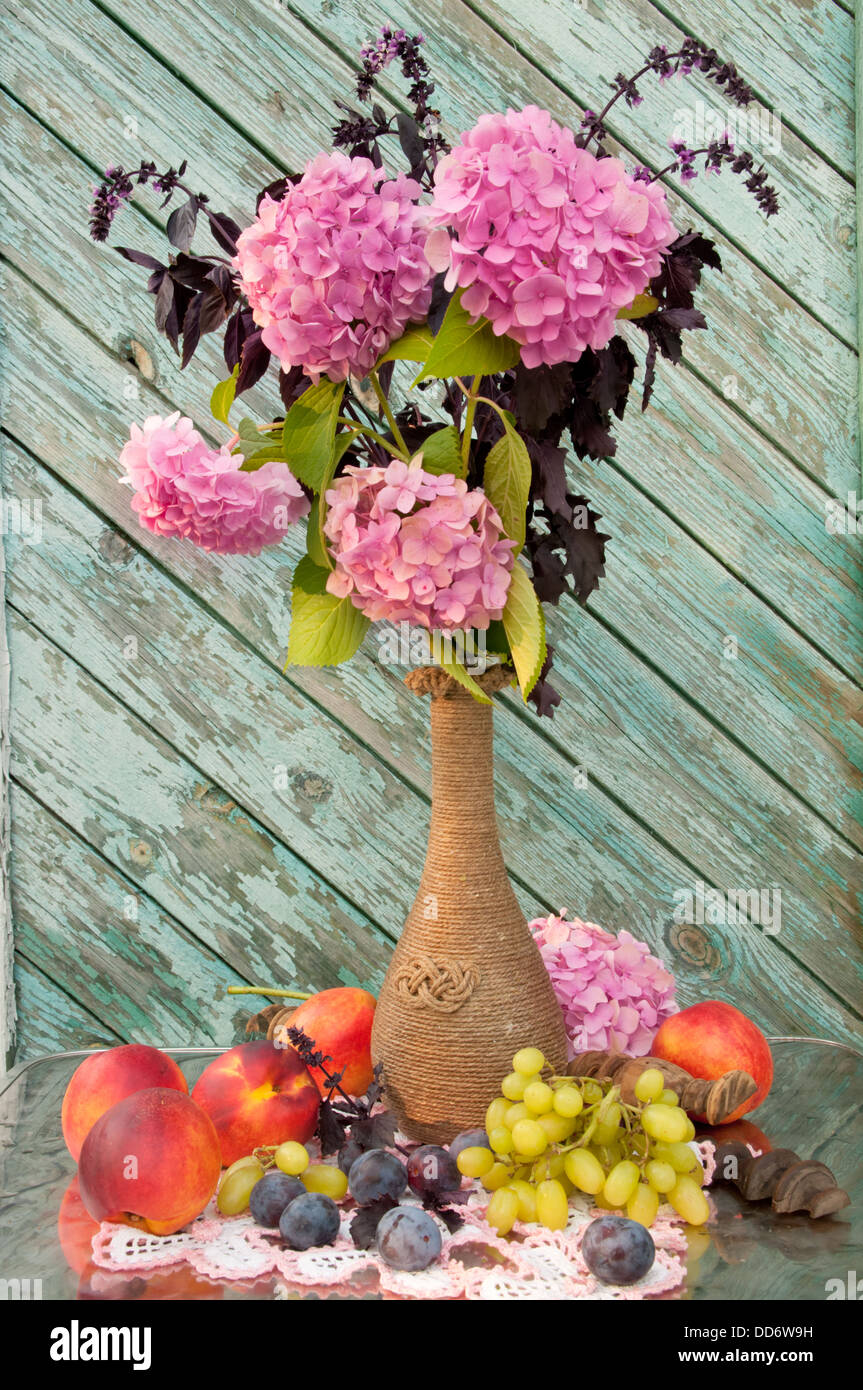 pink hydrangea and violet basil bouquet in a vintage vase still life Stock Photo
