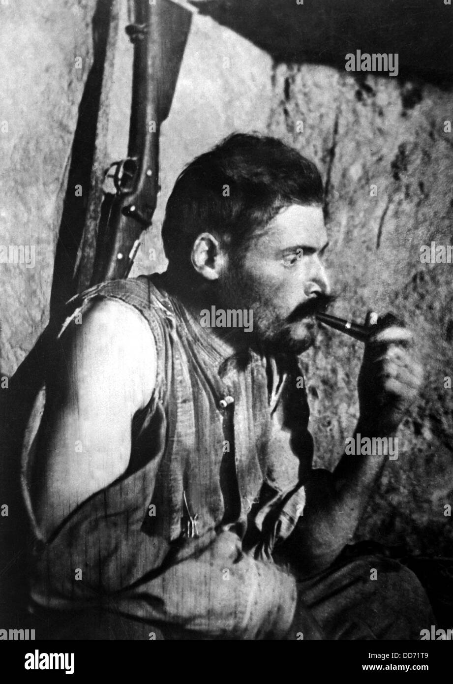 French World War I soldier smoking a pipe and resting after battle