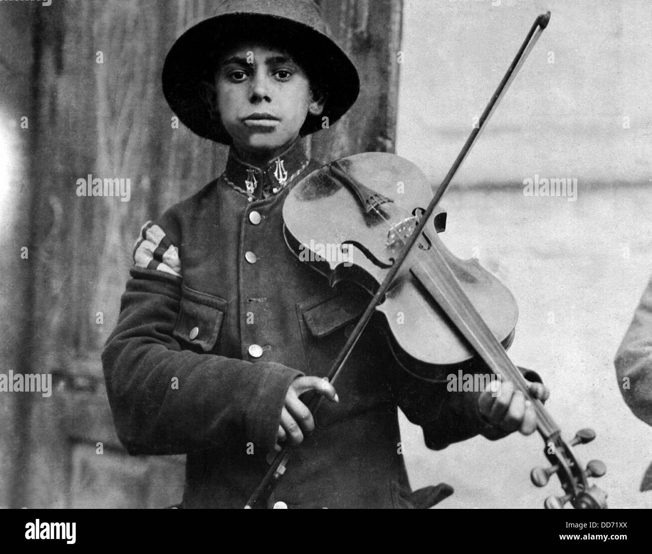 A young Christmas street fiddler, Belgrade, Serbia. Photo by Lewis Hine. Dec. 1918. Stock Photo