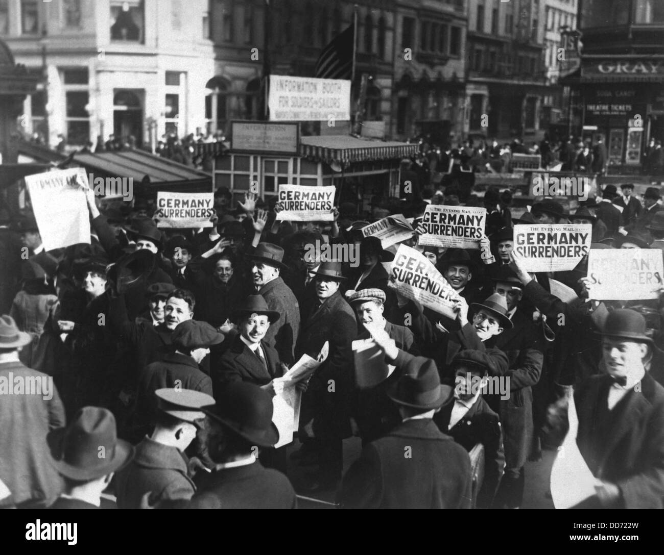 Headlines can be wrong. A crowd at Times Square holding up headlines reading 'Germany Surrenders,' on November 7, 1918. Four Stock Photo