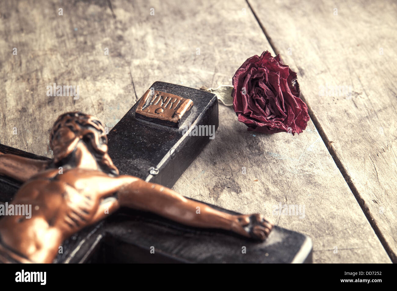 wooden Crucifix and rose on wooden background, close up photo Stock Photo