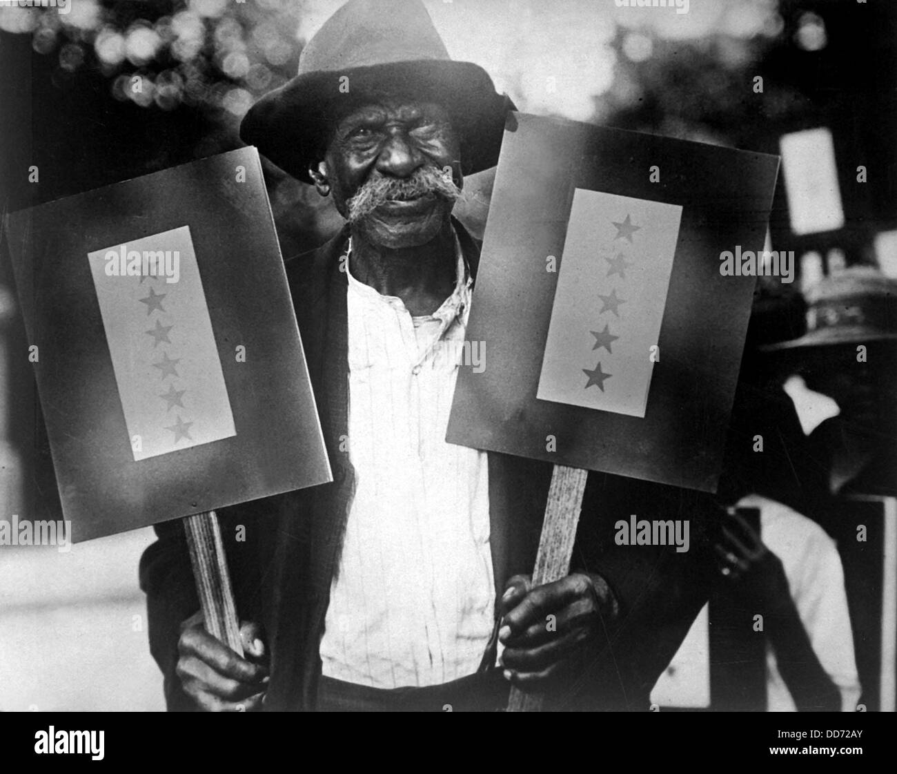 African American, Mr. Sims, of Atlanta, Georgia holding up banners with eleven stars. The 87 year old man had eleven sons Stock Photo