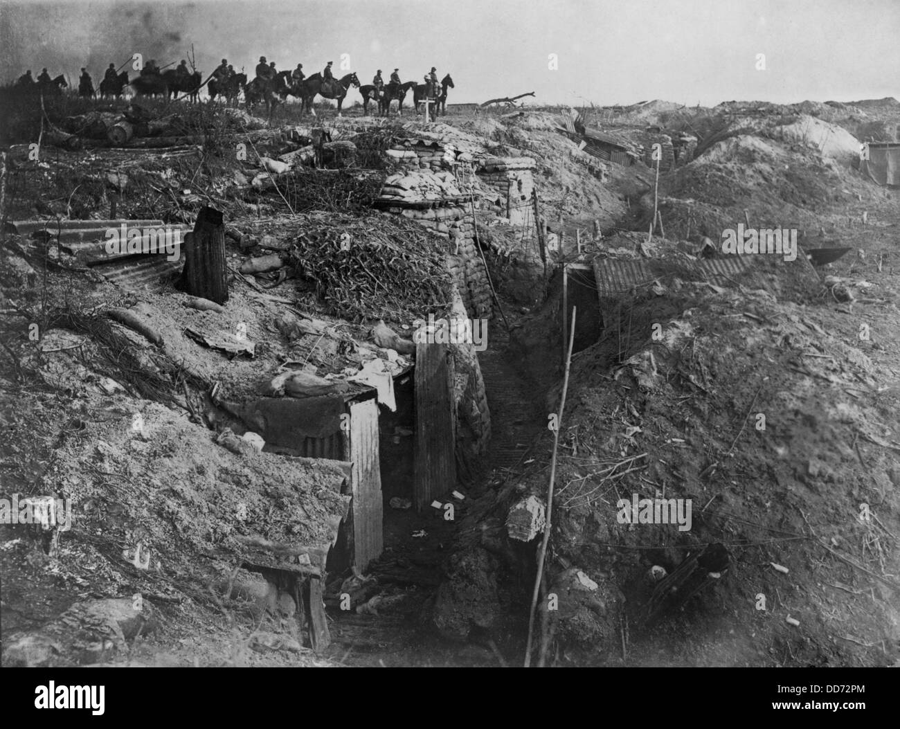 World War 1. Abandoned British trench which was captured by the Germans, who are on horseback in the background. Ca. 1915-18. Stock Photo