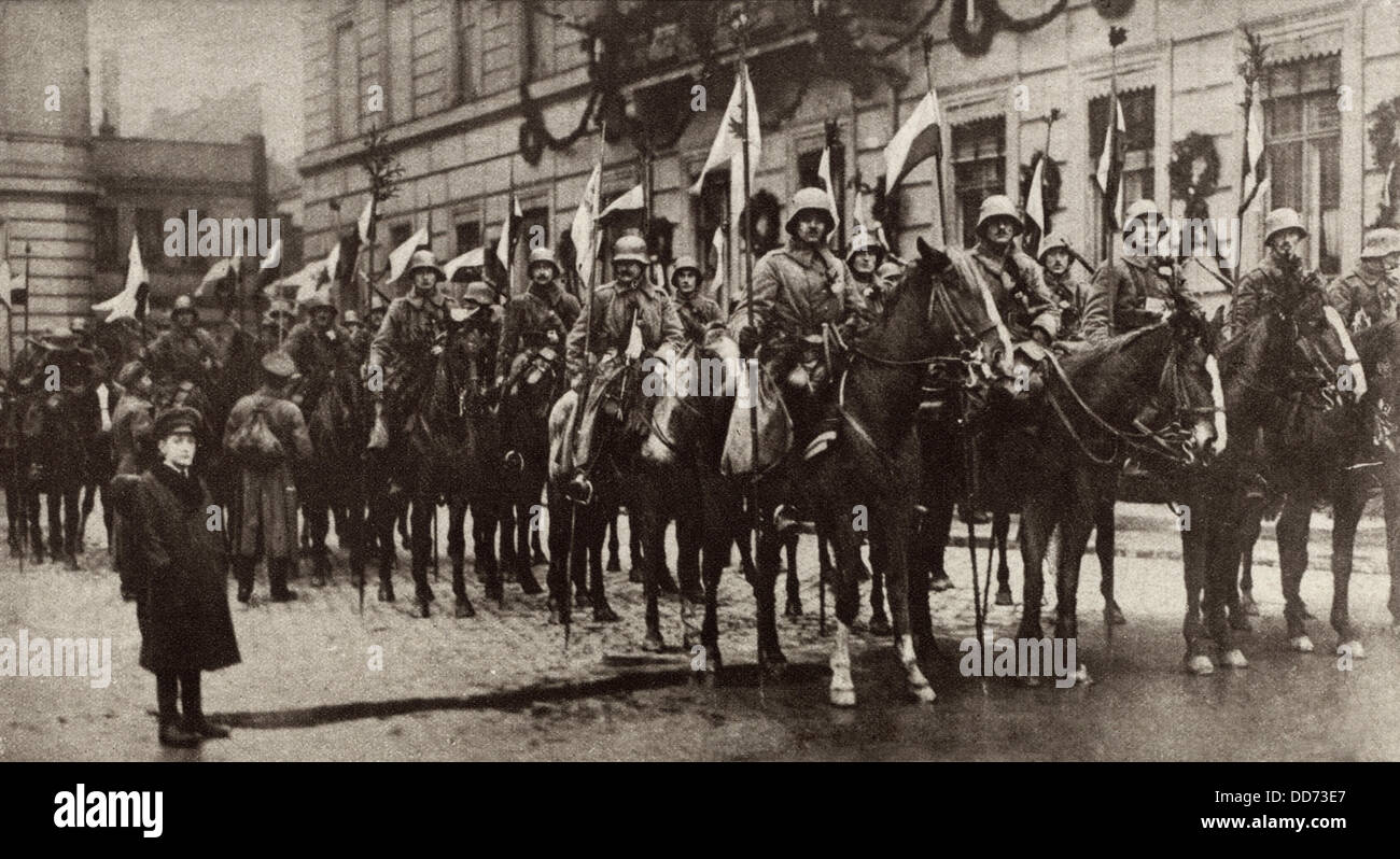 German soldiers welcomed home from the World War 1. 1918. Squadron of Prussian cavalry with decorated flagstaffs standing Stock Photo