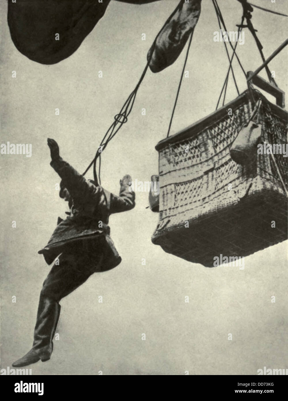 German WW1 observer jumping from burning balloon harnessed to a parachute. 1916-18. The parachute was attached to the basket's Stock Photo