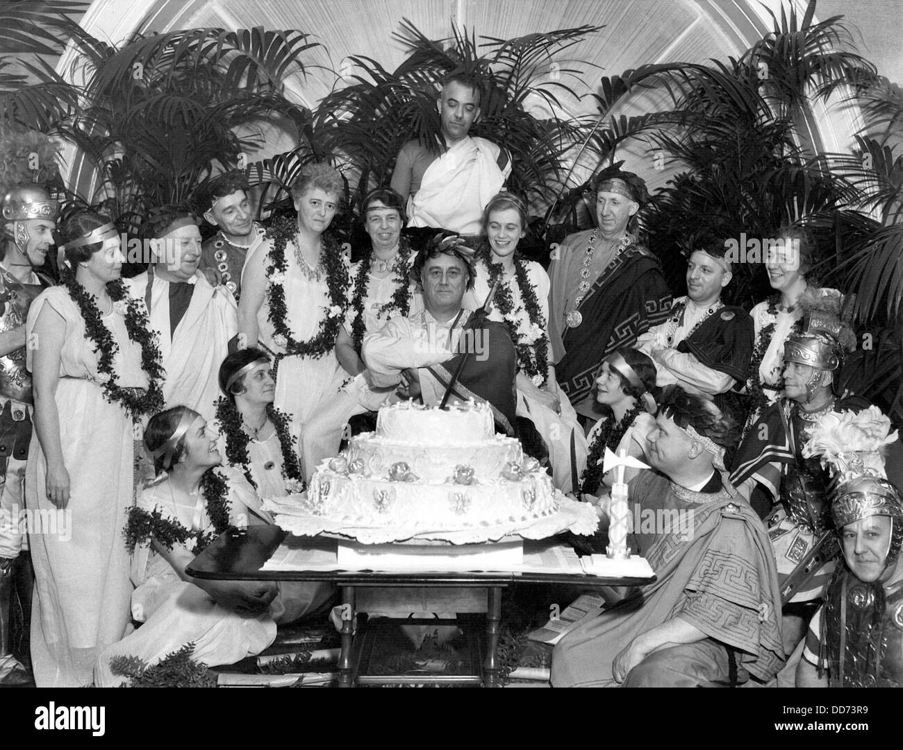 FDR celebrating his 52nd birthday at a toga party. Jan. 30, 1934. With the President are Marvin McIntyre, Grace Tully, Tom Stock Photo